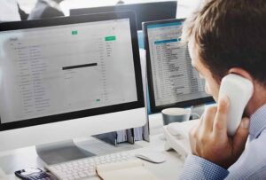 Office professional using a Contact Management System and organizing client information